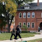 Michigan State University students walk near Chittenden Hall, the home of graduate school.