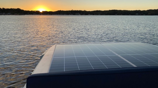 A solar panel at sunset in a Lilypad boat on the Kalamazoo River. A fully charged boat can run all night