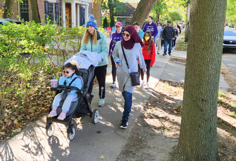 Participants walk through the Burns Park neighborhood in Ann Arbor on Oct. 9 as part of the annual Walk a Mile in My Shoes fundraiser.