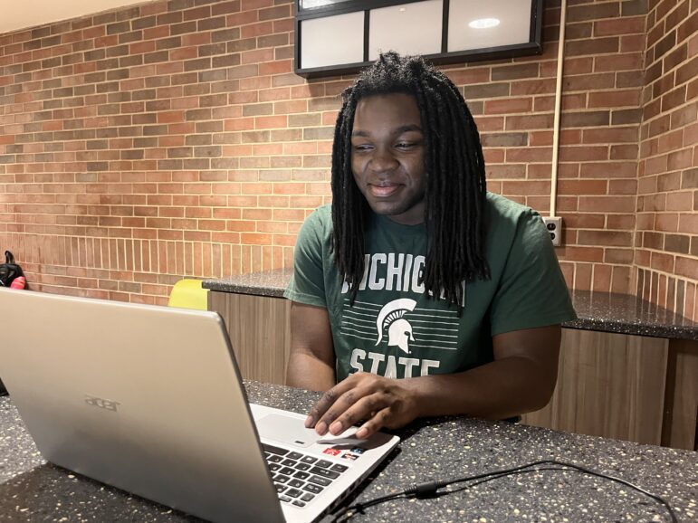 Michigan State University undergraduate Kamal Lea works on his computer.