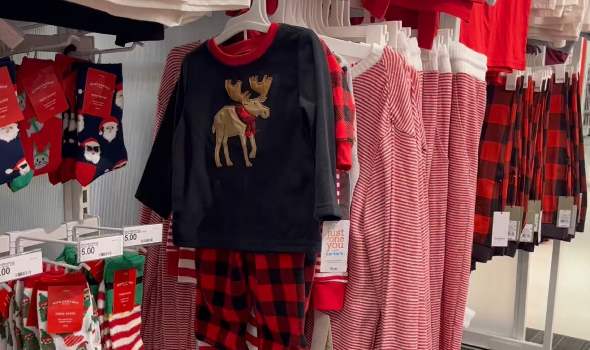 Christmas-themed clothing hangs on a display in the Meridian Mall in Okemos.