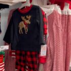 Christmas-themed clothing hangs on a display in the Meridian Mall in Okemos.