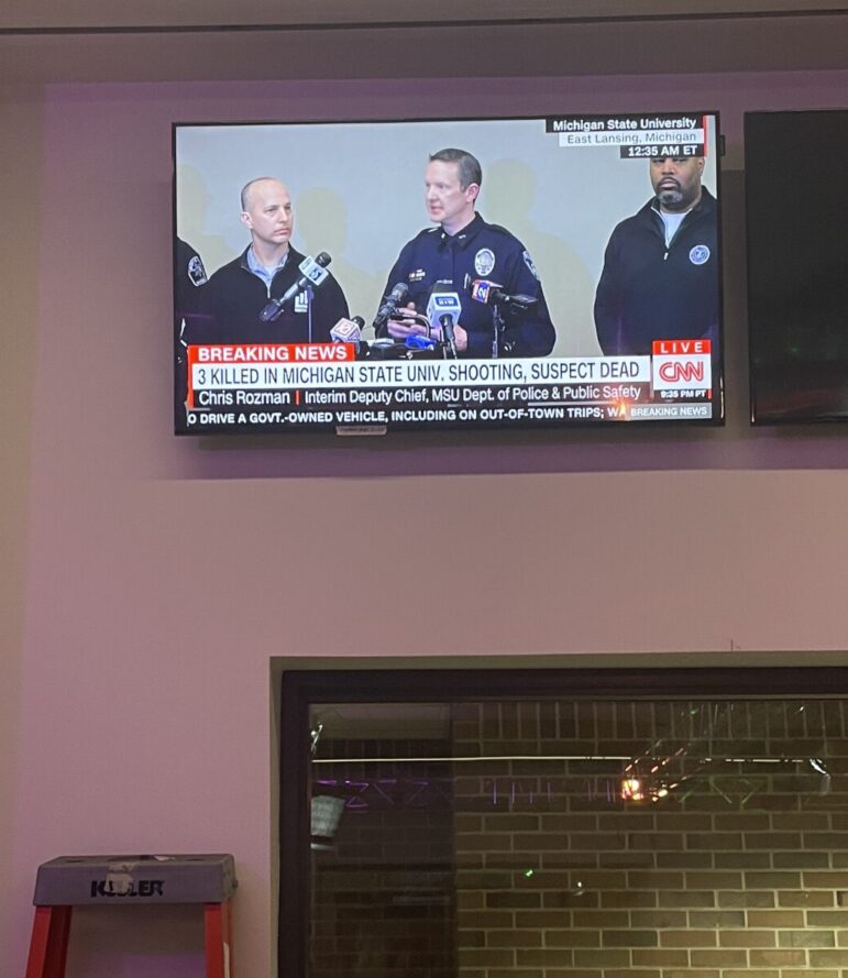 TV in the Spartan Newsroom shows CNN reporting on MSU shooting