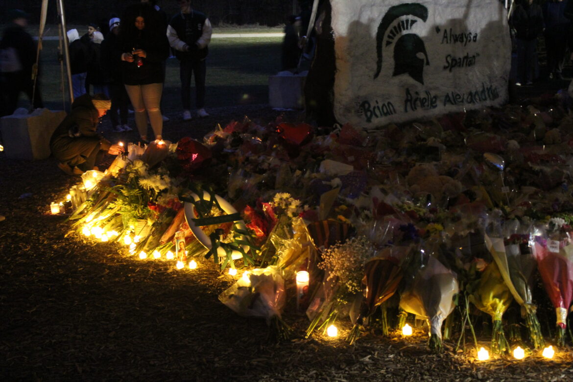 The MSU rock covered with flowers and candle lights during the vigil.