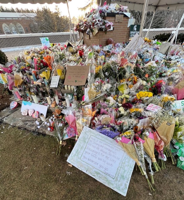 Flowers are placed on the campus of Michigan State University prior to a vigil on Feb. 24.