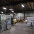 Aluminum cans and bottles are pressed into bricks of recyclable material, waiting to be shipped and formed into new beverage containers.