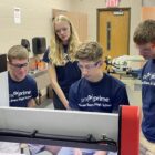 Students work with manufacturing equipment at Three Rivers High School