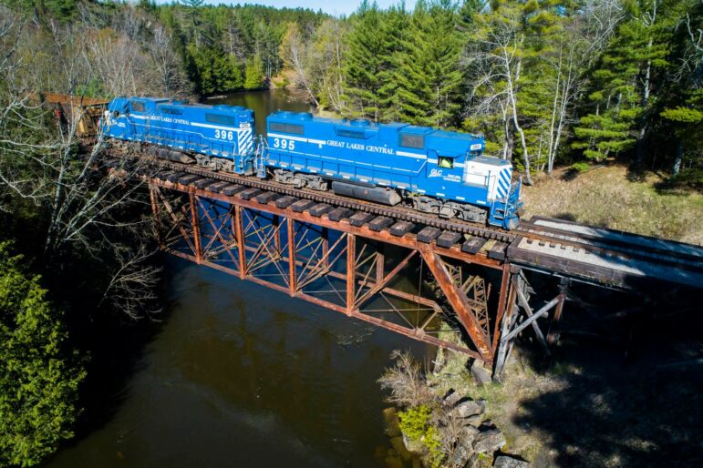 A Great Lakes Central Railroad train crosses the Manistee River Train Bridge. 