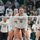 MSU volleyball players wait in front of the net for a serve from Nebraska.