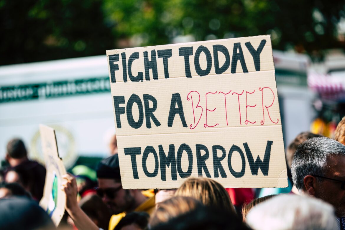 Sign held that says "fight today for a better tomorrow."