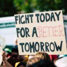 Sign held that says "fight today for a better tomorrow."