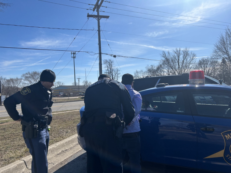 Trooper David Versin searches the driver he initially pulled over for having expired tags and later arrested on an outstanding warrant in a drug case.