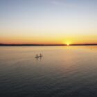 Paddle boarders cross Platte Lake where a decades-long campaign reduced algal blooms caused by runoff from a fish hatchery.